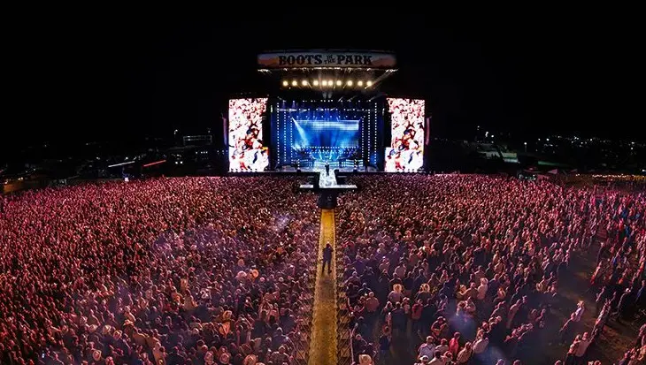 Large outdoor concert crowd at night.