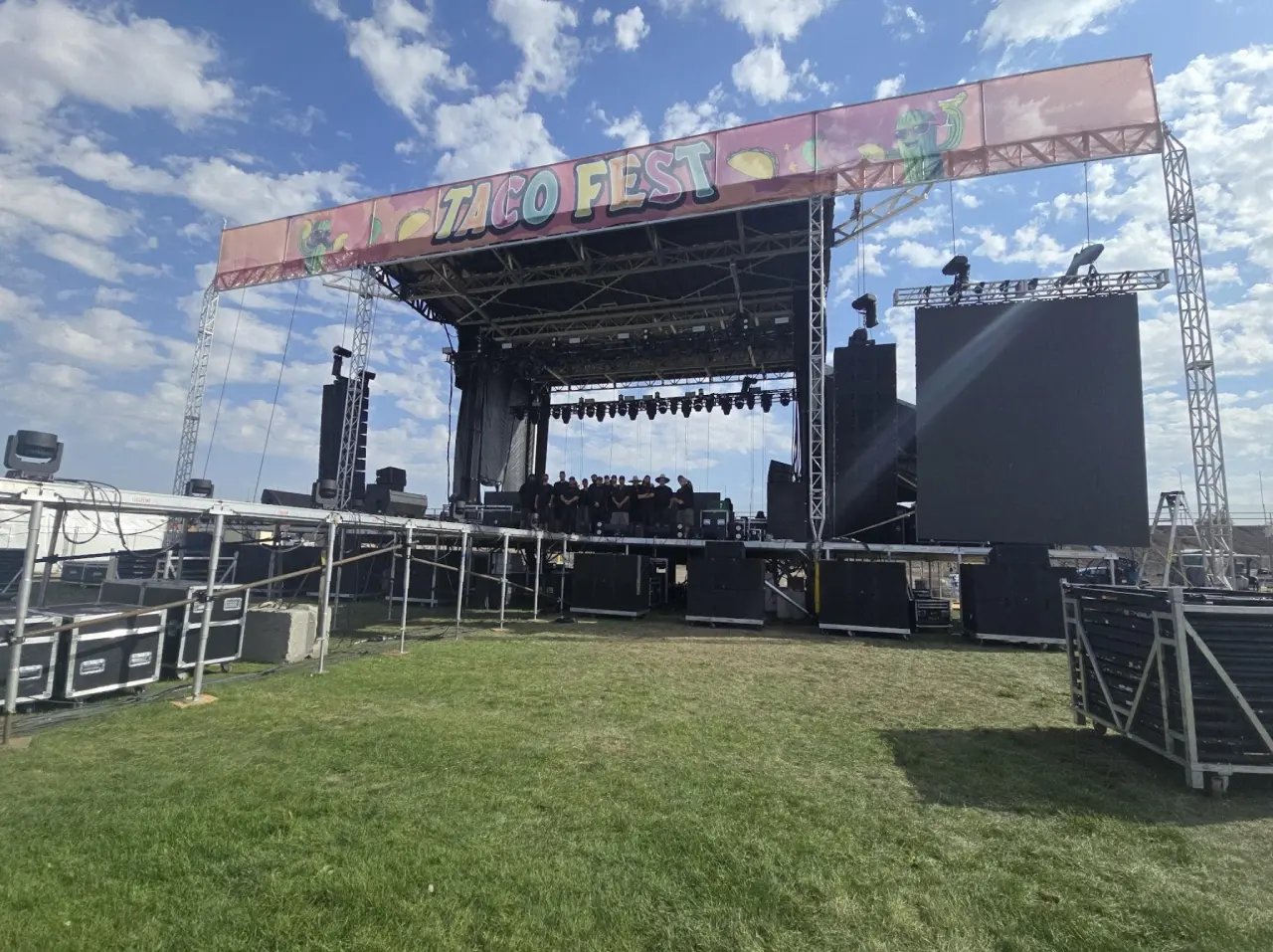 Outdoor festival stage setup under blue sky.