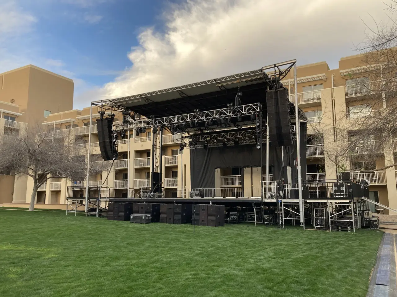 Outdoor stage setup on green lawn.