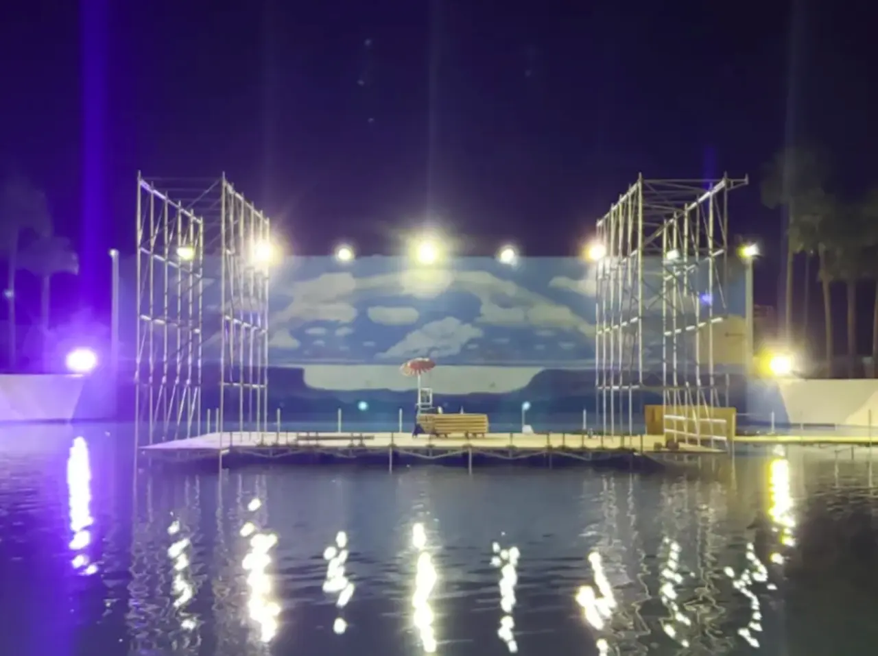 Floating stage with lights at night.
