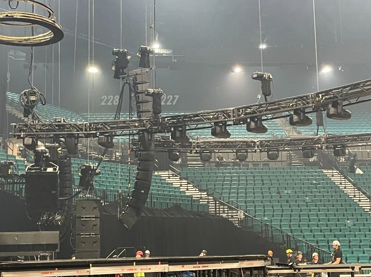 Arena stage setup with lighting equipment overhead.