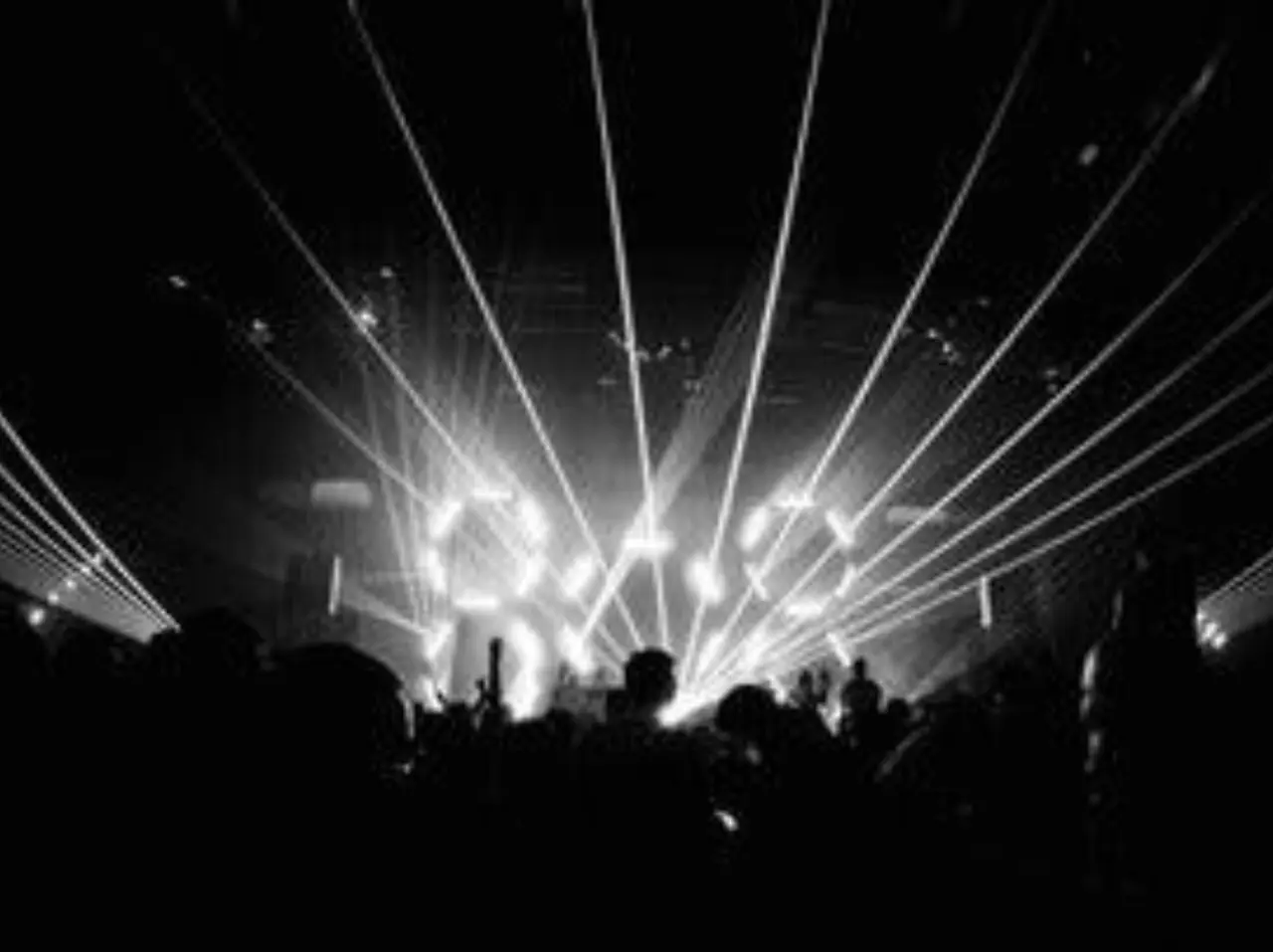 Concert with bright lights and laser beams.