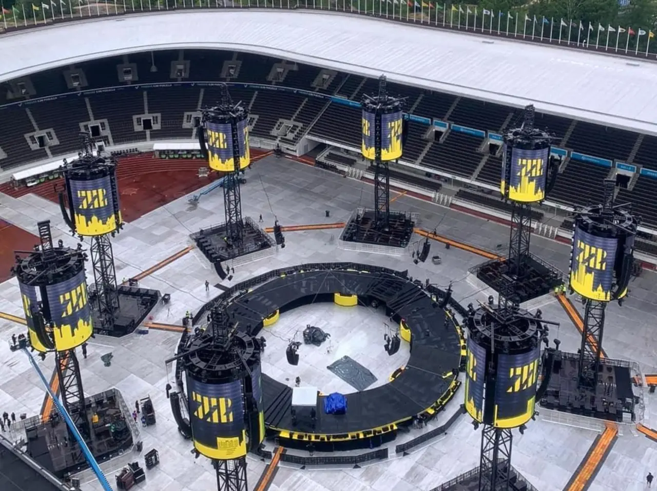 Concert stage setup in large outdoor stadium.
