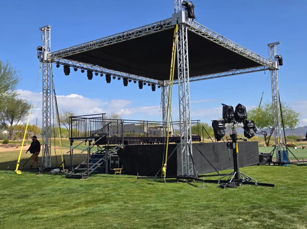 Outdoor stage setup on grassy field.