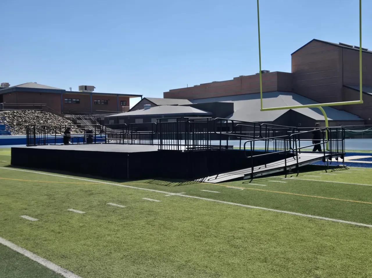 Outdoor stage set up on football field.
