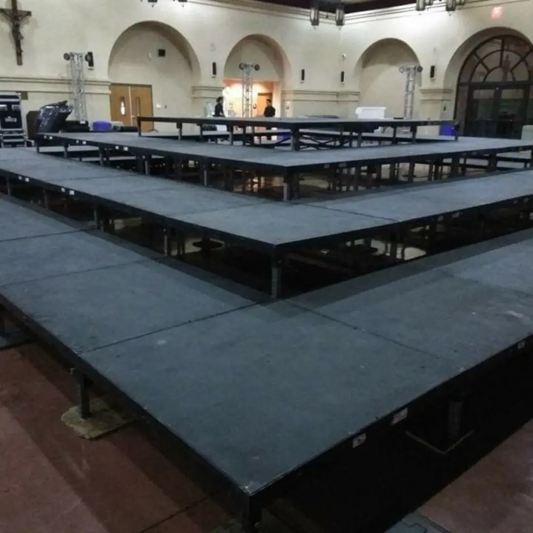 Indoor stage setup with lighting equipment.